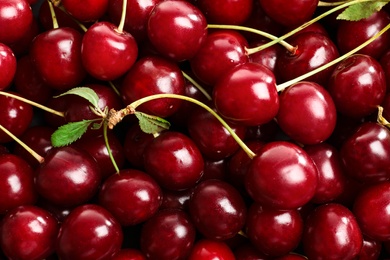 Photo of Delicious ripe sweet cherries as background, closeup view