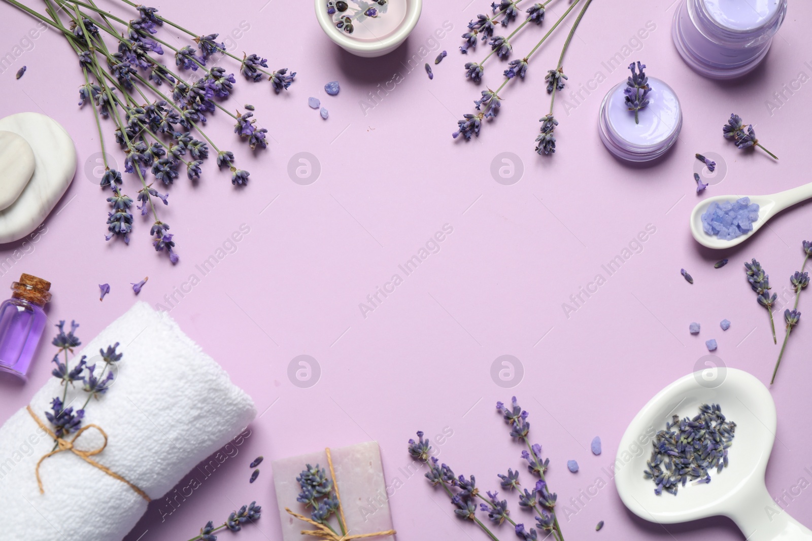 Photo of Cosmetic products and lavender flowers on lilac background, flat lay. Space for text