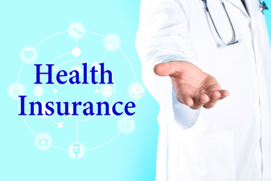 Image of Phrase Health Insurance, icons and medical doctor on light blue background, closeup