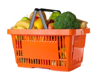 Photo of Shopping basket with grocery products on white background