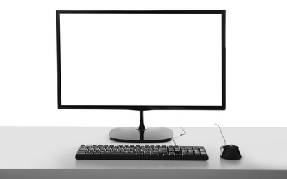 Photo of Modern computer monitor with black screen, keyboard and mouse on white background