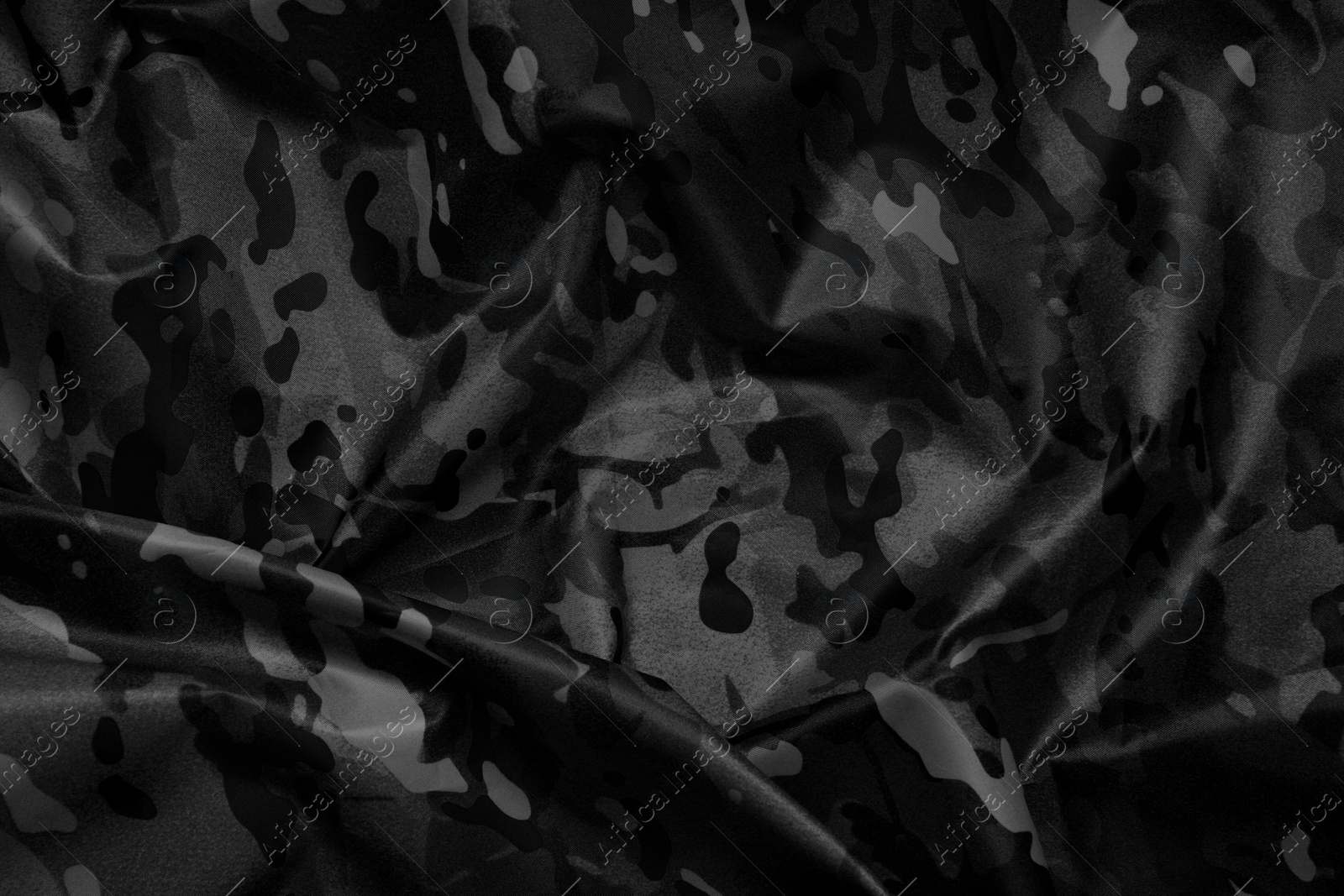 Image of Texture of crumpled camouflage fabric as background, top view. Black and white effect