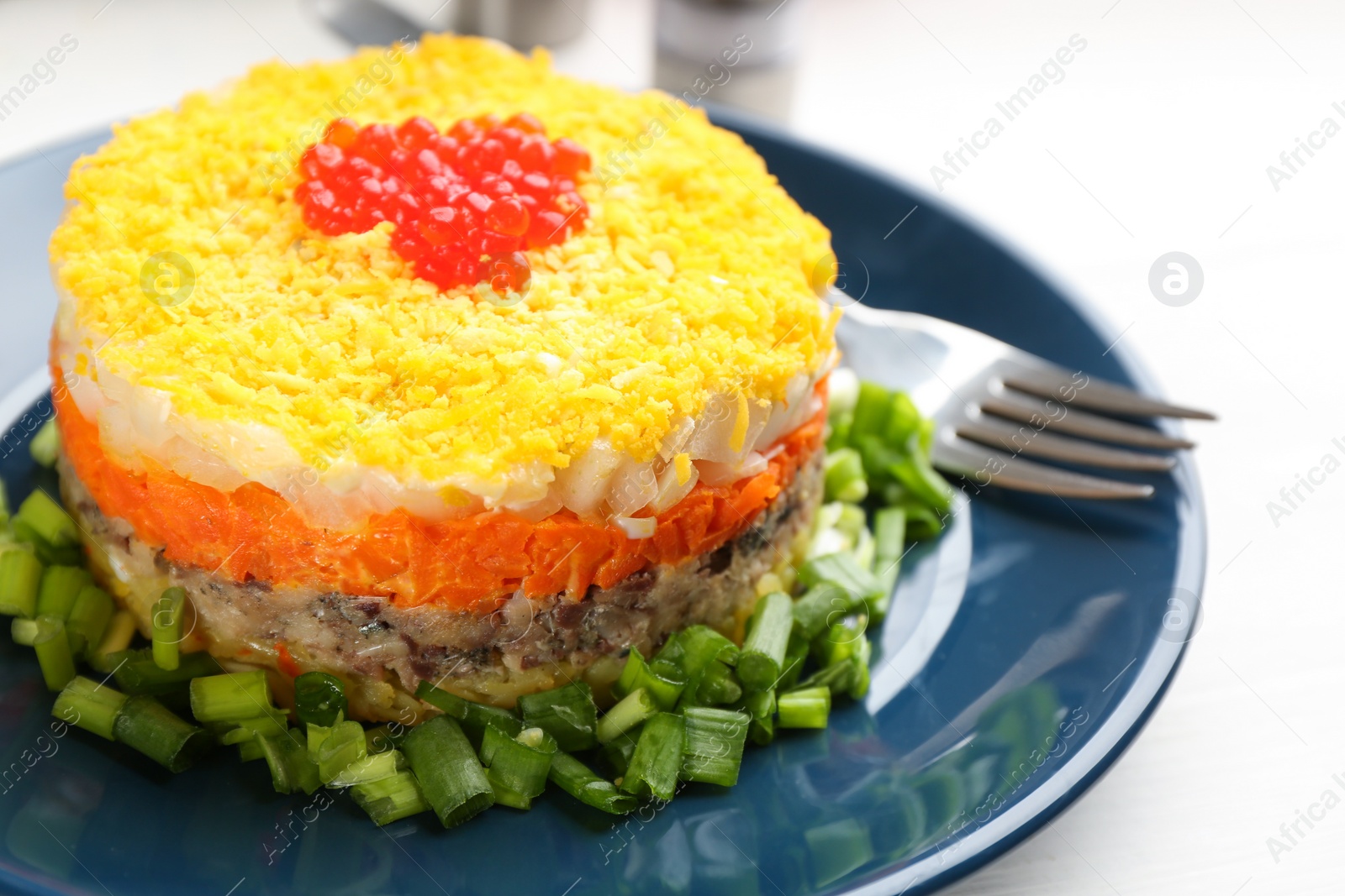 Photo of Traditional russian salad Mimosa served on white table, closeup