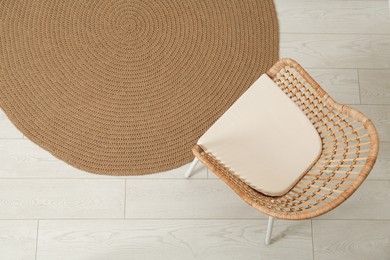 Photo of Stylish wicker armchair in room, top view