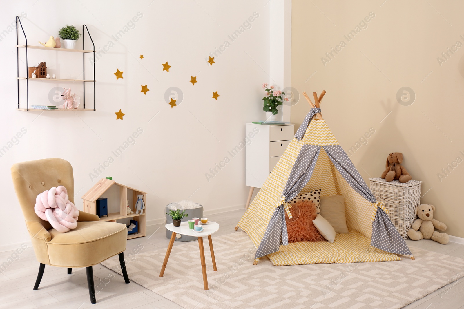 Photo of Cozy kids room interior with play tent and toys