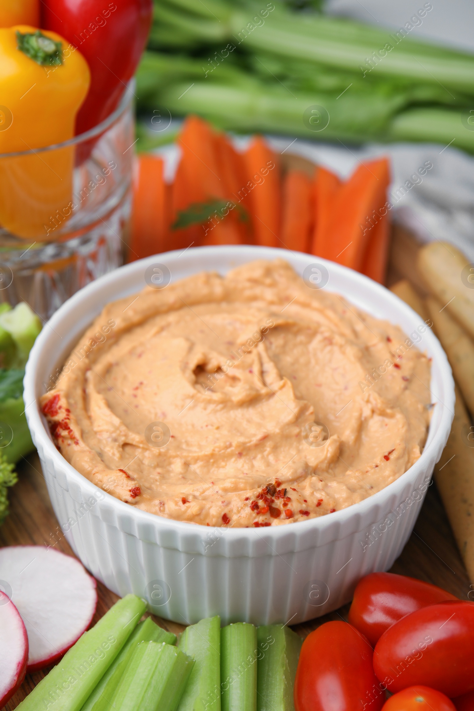 Photo of Delicious hummus and fresh vegetables, closeup view