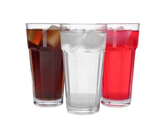 Photo of Glasses of different refreshing soda water with ice cubes isolated on white