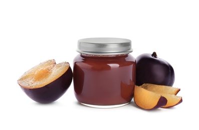 Jar with healthy baby food and ripe plums on white background