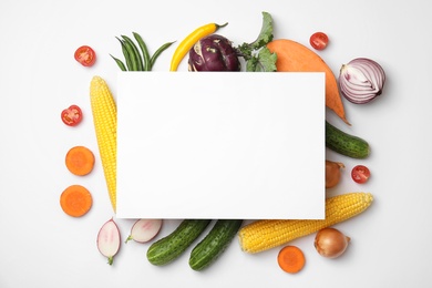 Flat lay composition with fresh vegetables and blank card for text on white background