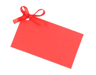 Photo of Blank red gift tag with satin ribbon on white background, top view