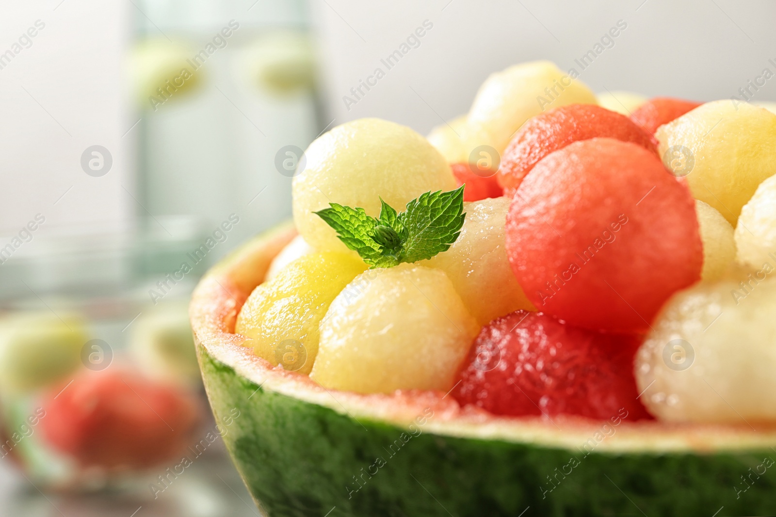 Photo of Melon and watermelon balls with mint served on table, closeup