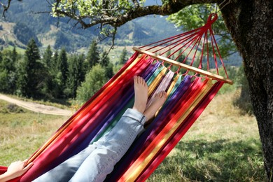 Photo of Woman resting in hammock outdoors on sunny day, closeup