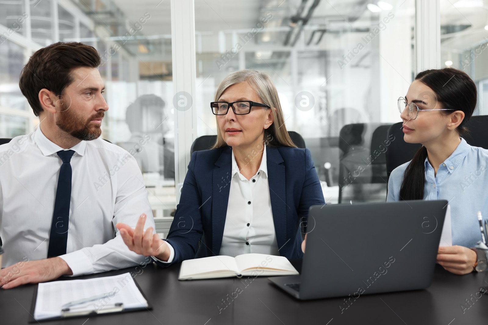 Photo of Lawyers working together at table in office