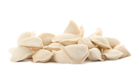 Photo of Heap of raw dumplings on white background