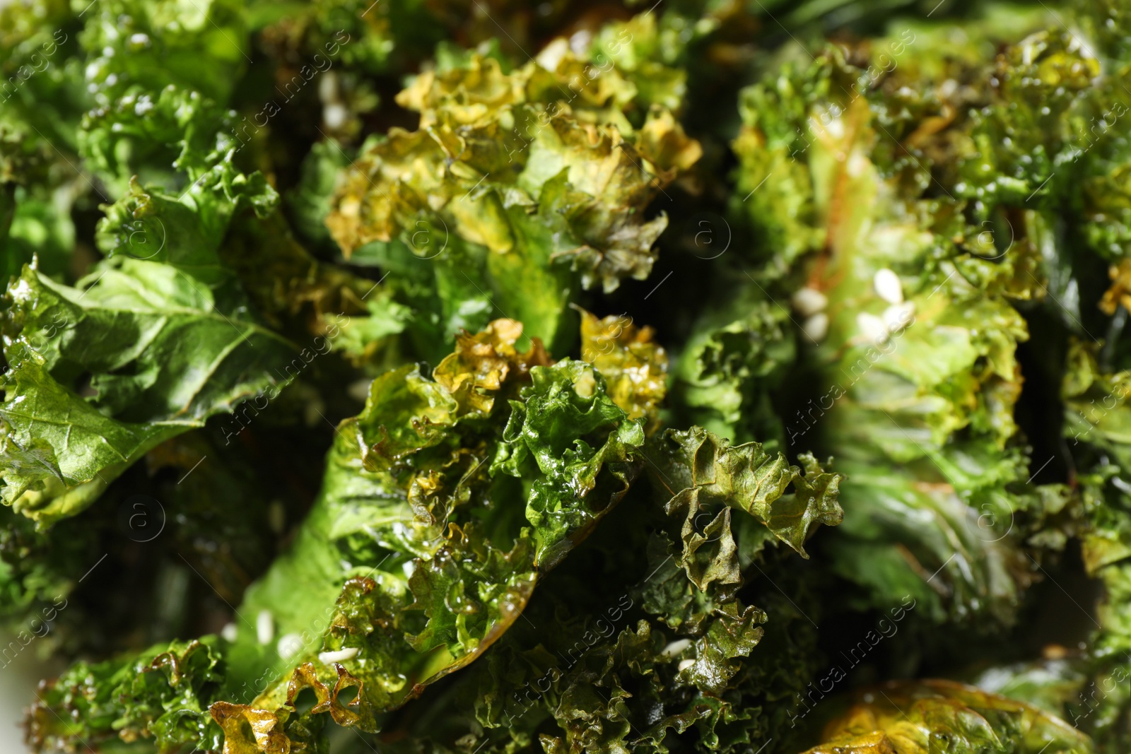 Photo of Baked tasty kale chips as background, closeup