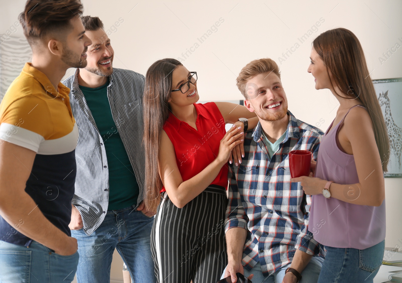 Photo of Group of happy people talking in office