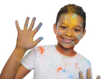 Photo of African American boy covered with colorful powder dyes on white background. Holi festival celebration