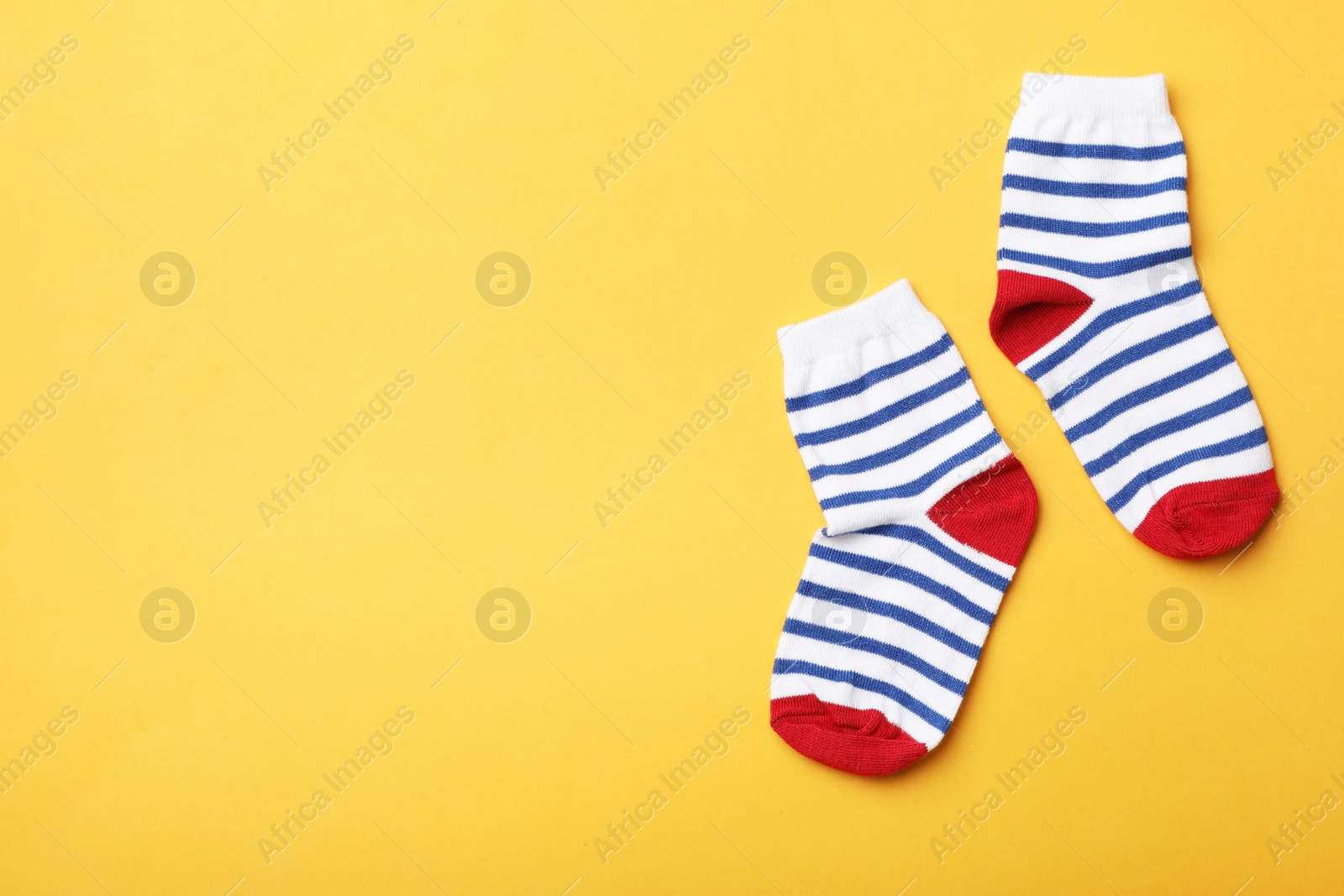 Photo of Cute child socks on color background, flat lay. Space for text