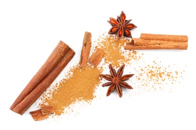 Dry aromatic cinnamon sticks, powder and anise stars isolated on white, top view