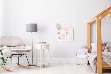 Stylish child room interior with comfortable bed