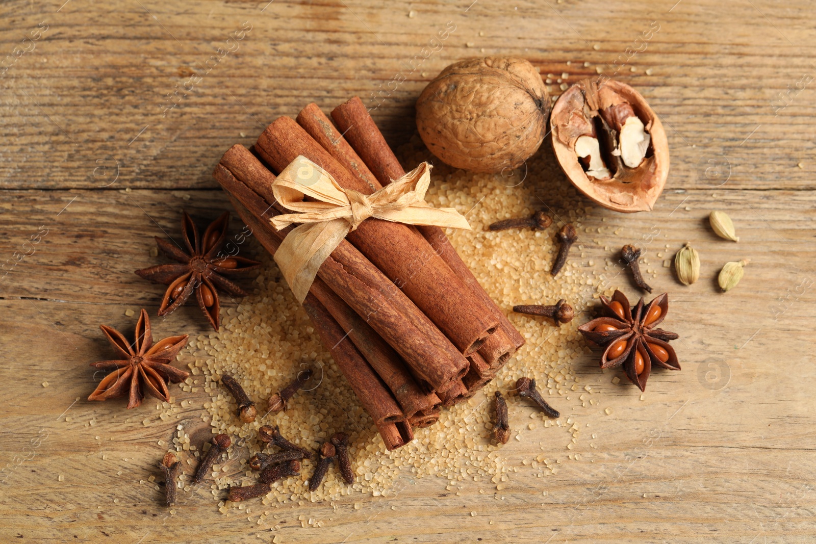 Photo of Different spices and nuts on wooden table, flat lay