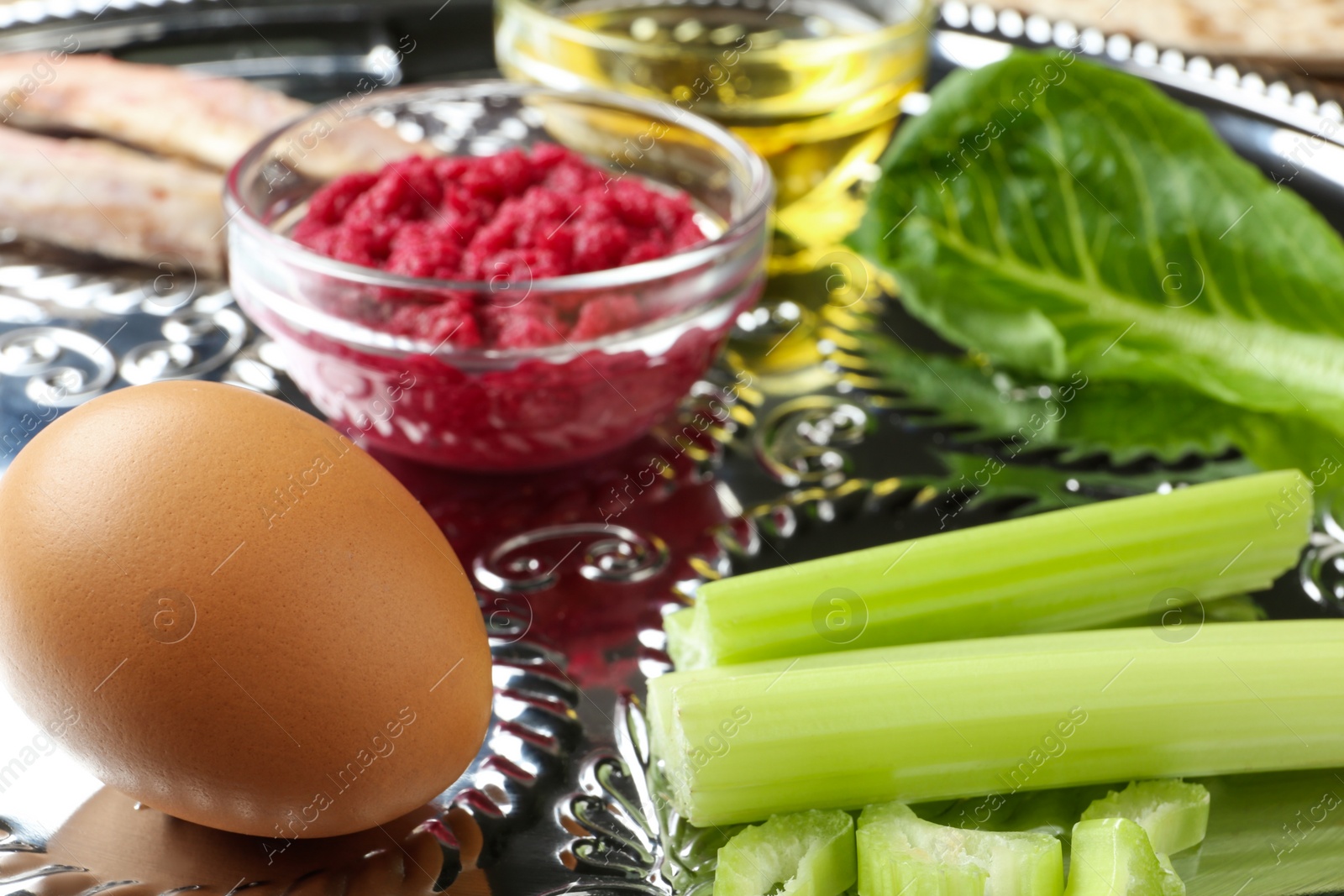 Photo of Closeup view of Passover Seder plate (keara) with traditional meal. Pesah celebration