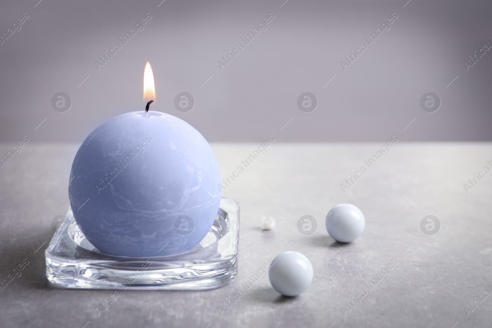 Photo of Round wax candle burning on table