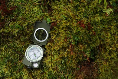 Photo of Compass on moss, above view. Space for text