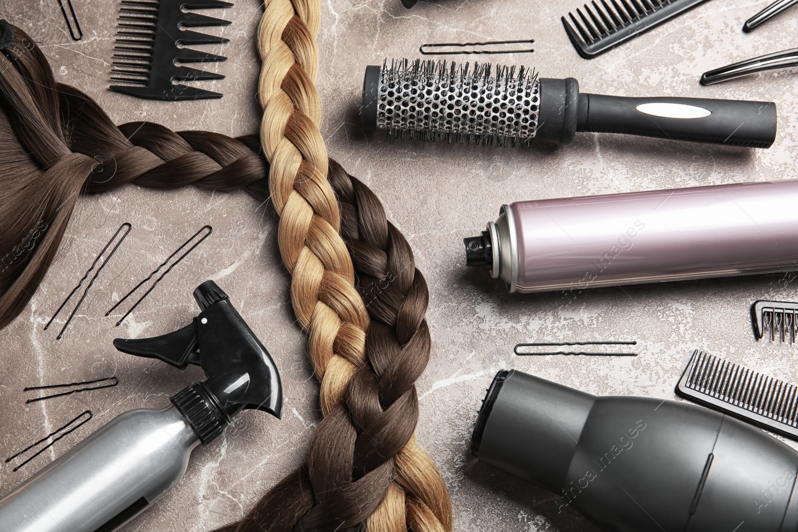 Photo of Flat lay composition with hair salon tools on grey background