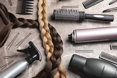 Photo of Flat lay composition with hair salon tools on grey background