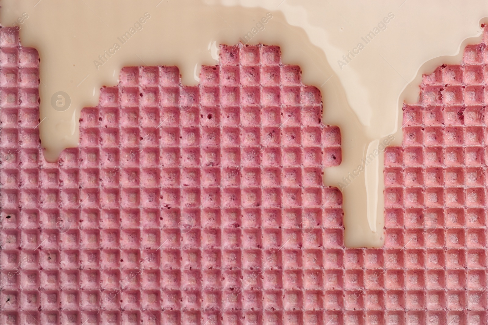 Photo of Hot white chocolate on wafer, closeup. Crispy food