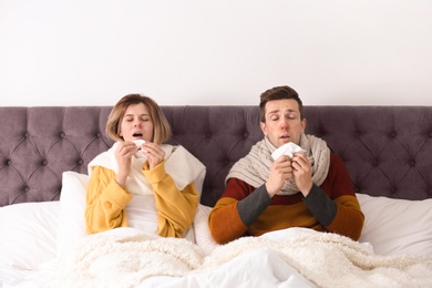 Photo of Couple suffering from cold together in bed