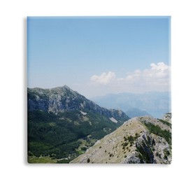 Image of Photo printed on canvas, white background. Picturesque view of beautiful mountains on sunny day