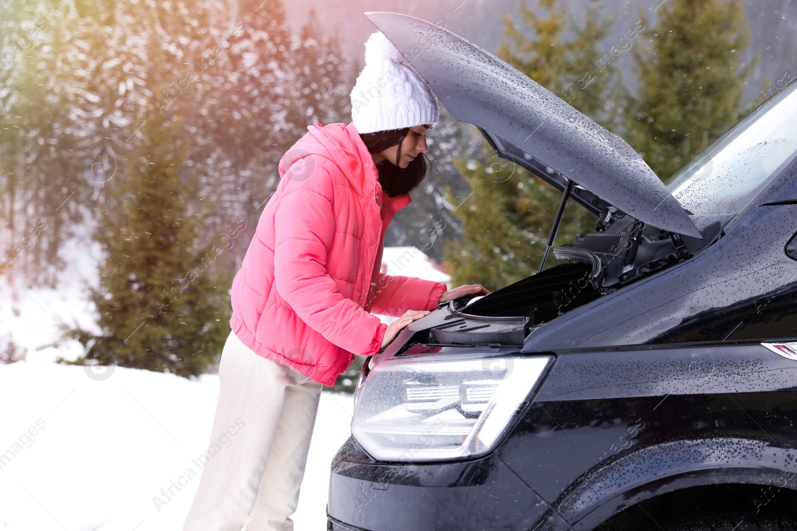 Photo of Stressed woman near broken car outdoors on winter day