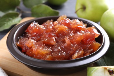 Photo of Bowl of delicious apple jam and fresh fruits on table, closeup