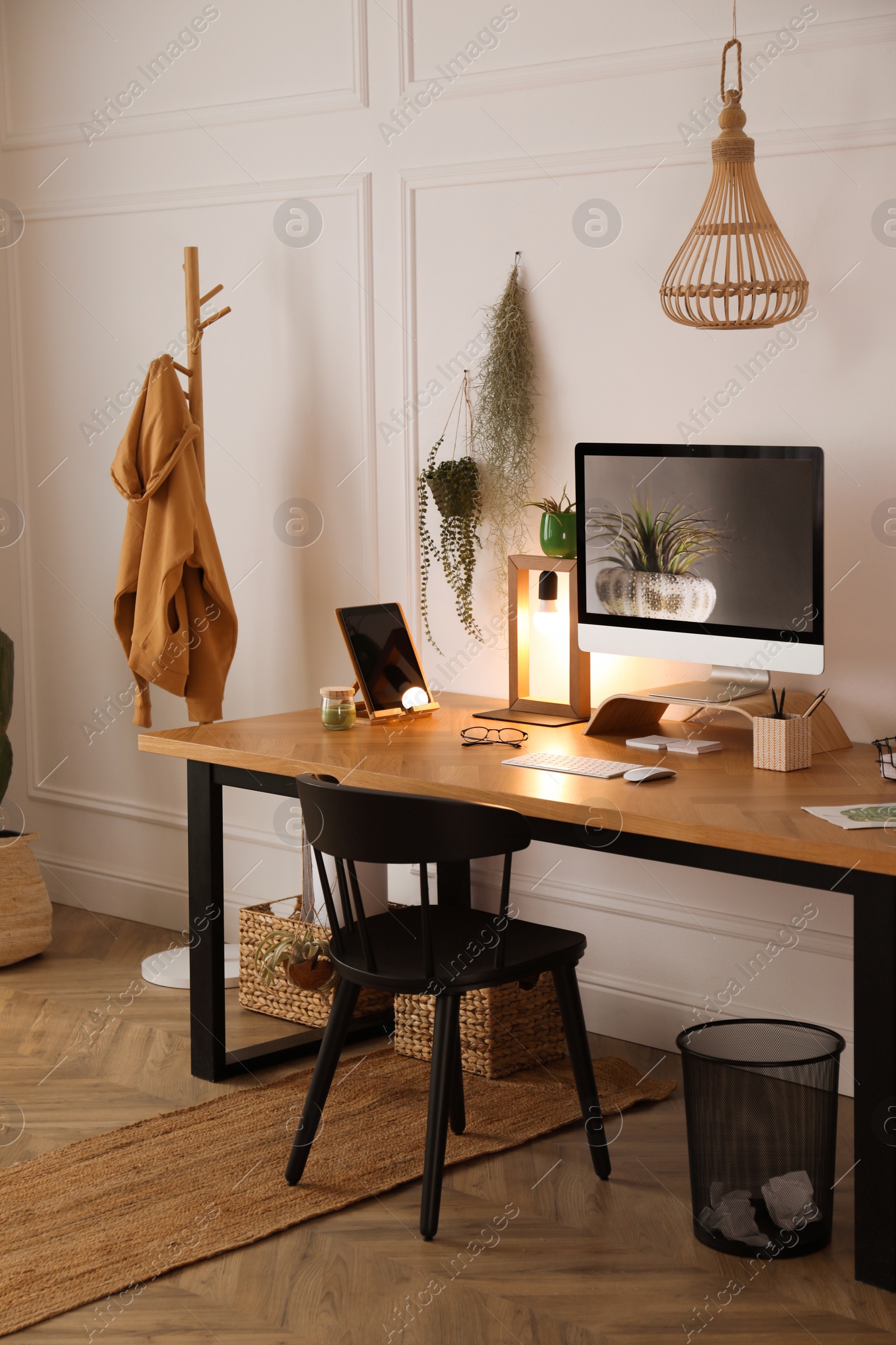 Photo of Modern workplace with computer in room. Interior design