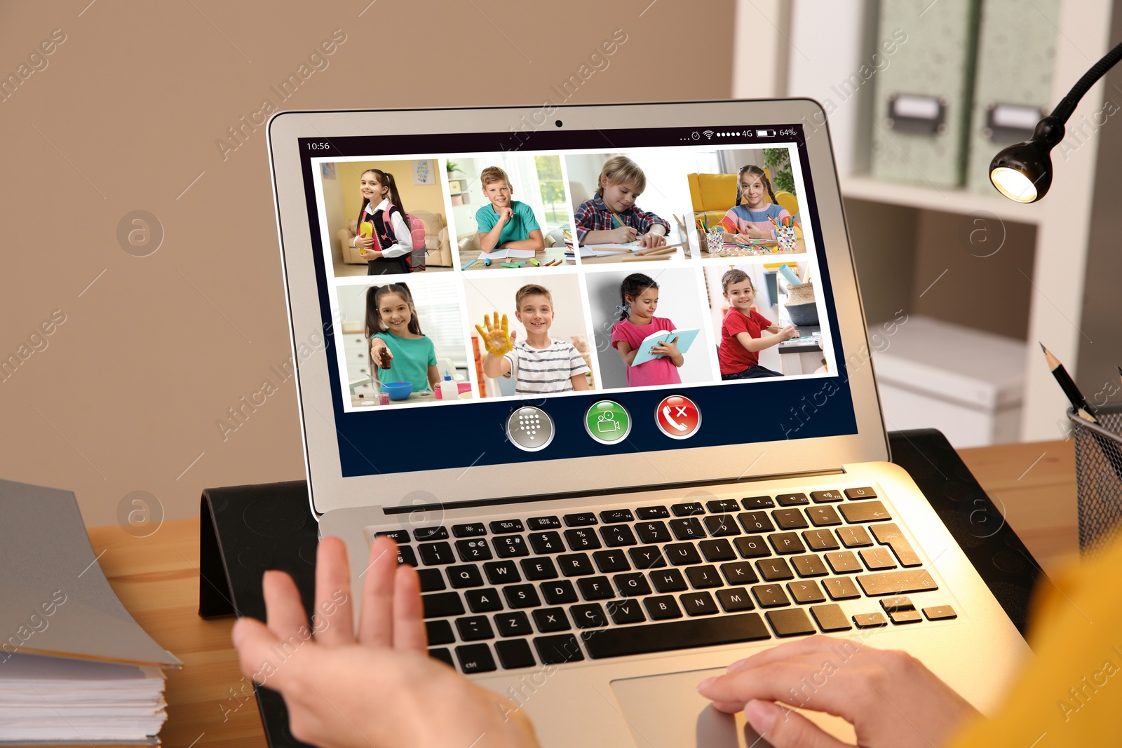 Image of Teacher giving online school lesson during quarantine and social distancing due to Covid-19 pandemic, closeup. Pupils studying at home via video conference