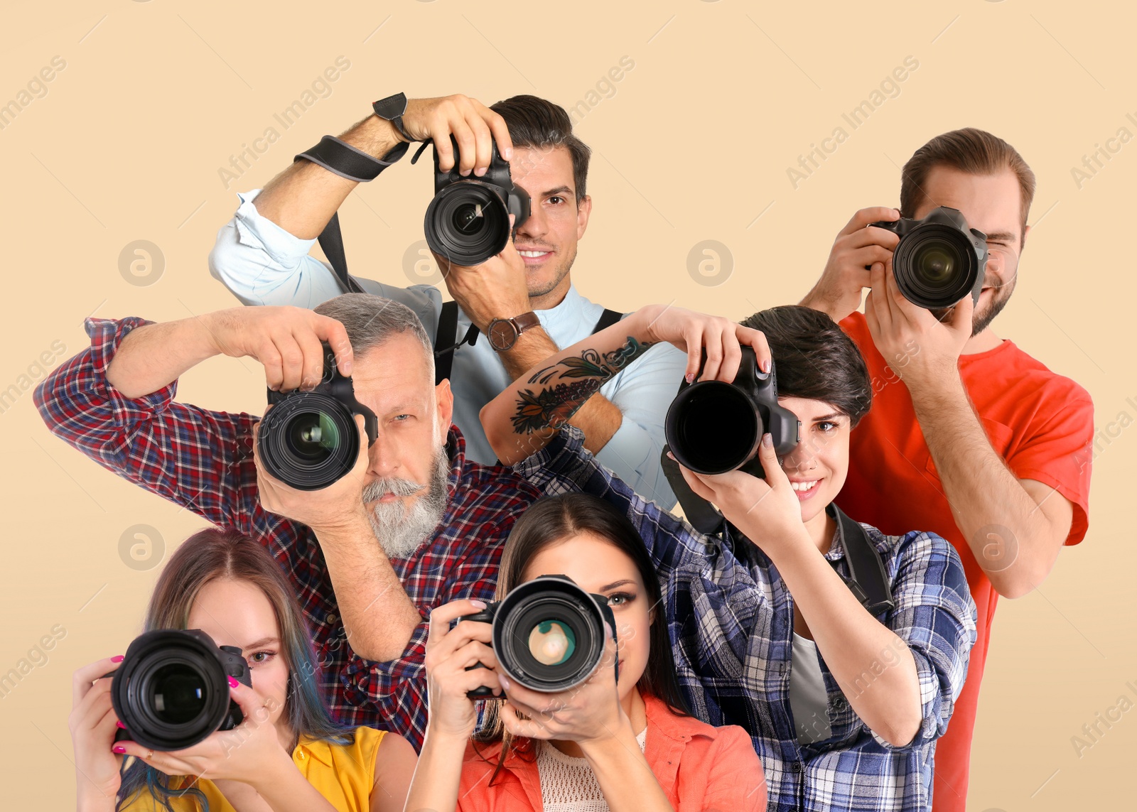 Image of Group of professional photographers with cameras on beige background