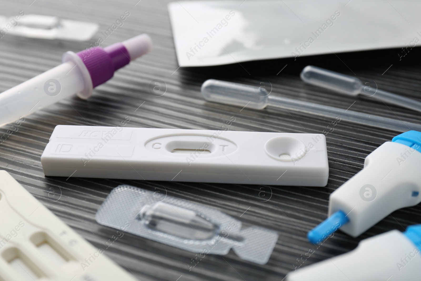 Photo of Disposable express test kits on black wooden table, closeup