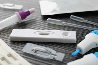 Photo of Disposable express test kits on black wooden table, closeup