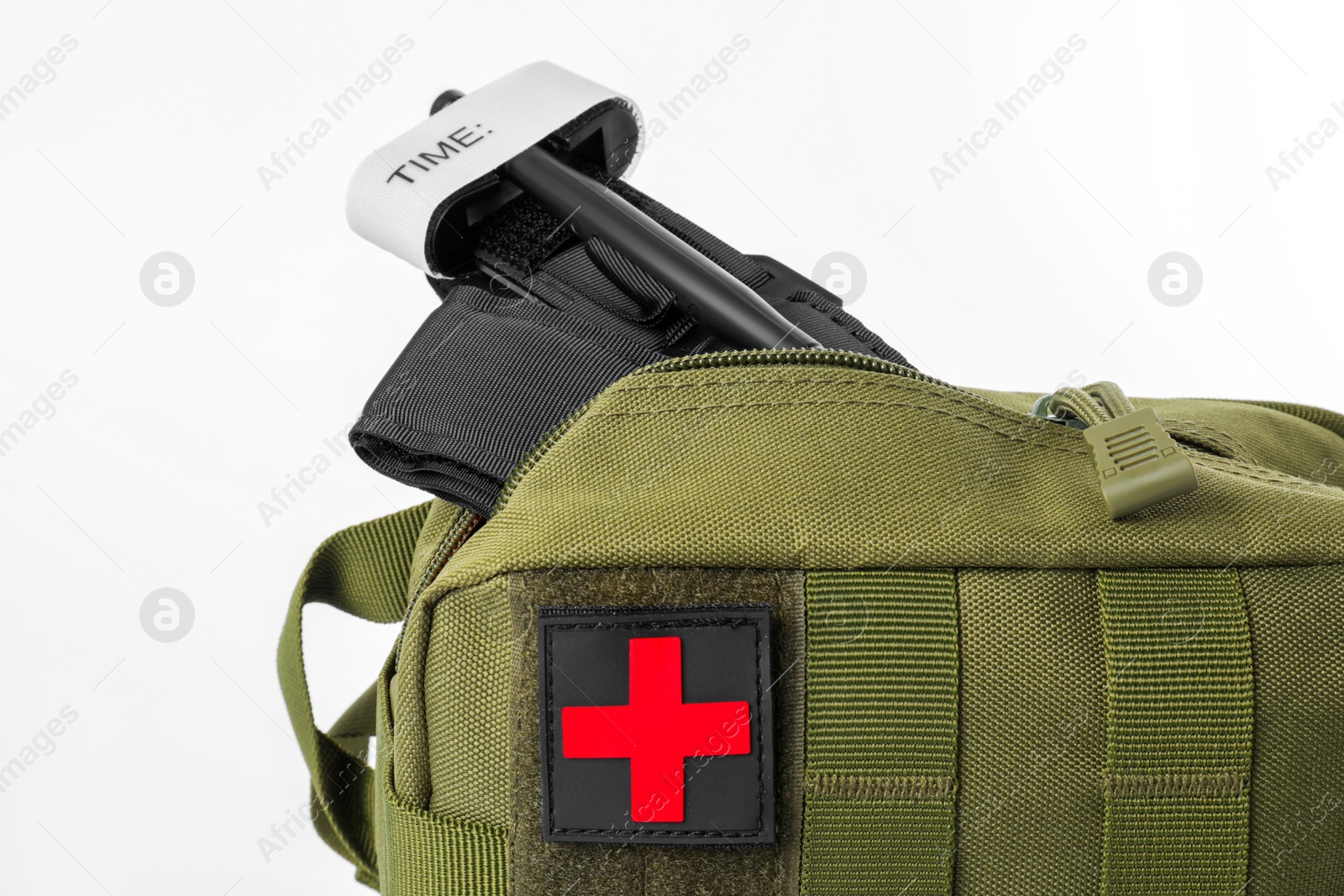 Photo of Military first aid kit and tourniquet isolated on white, closeup