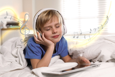 Image of Cute little boy listening to music at home. Notes illustration