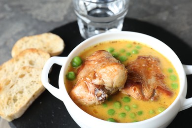 Photo of Tasty cooked rabbit meat with sauce served on table, closeup