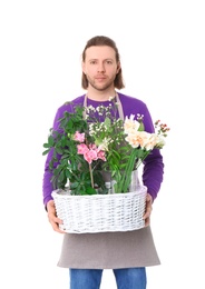 Photo of Male florist holding basket with flowers on white background