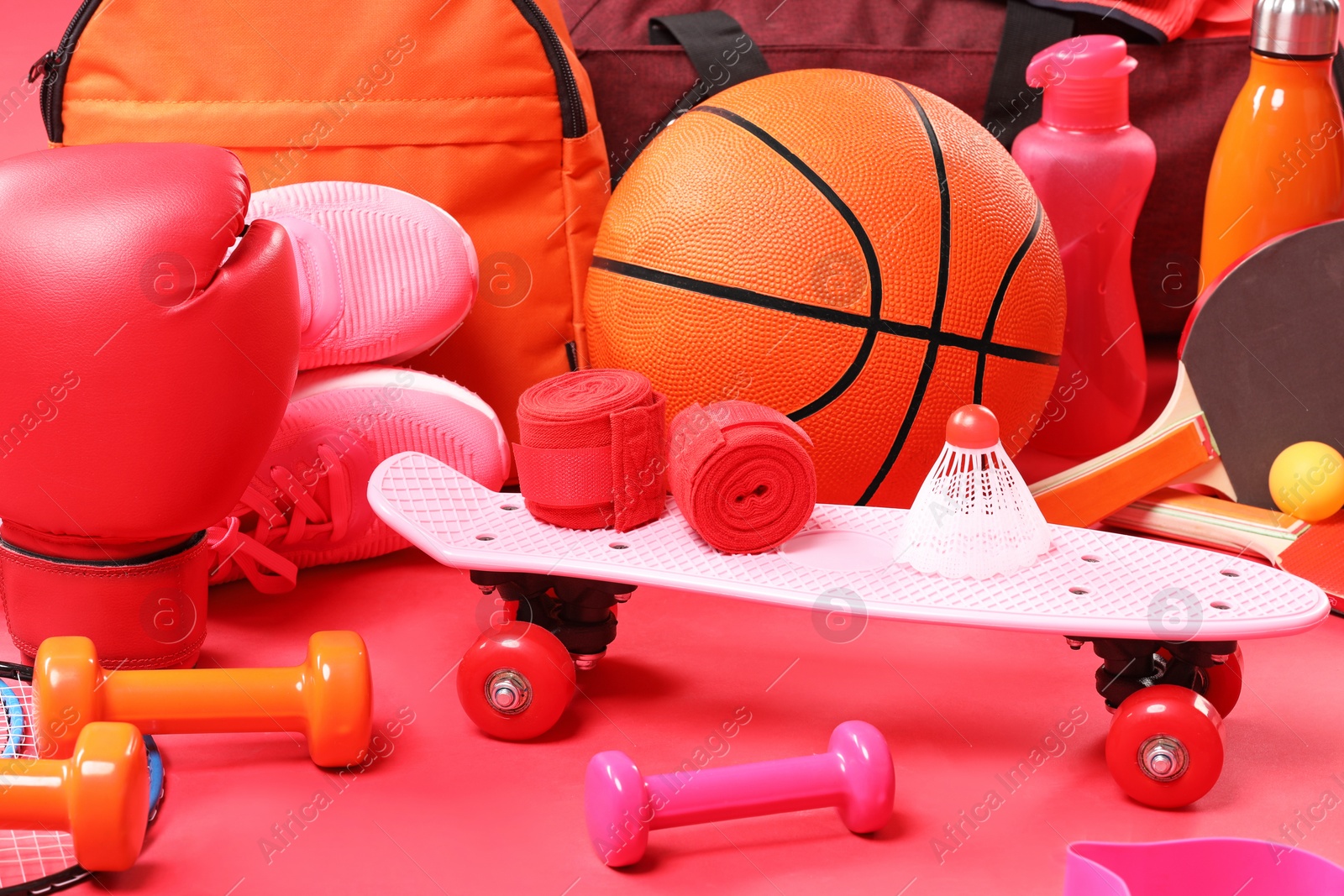 Photo of Many different sports equipment on red background