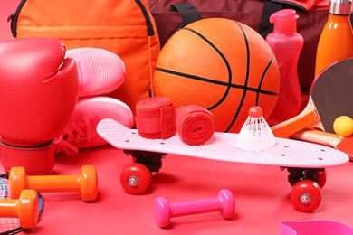 Photo of Many different sports equipment on red background