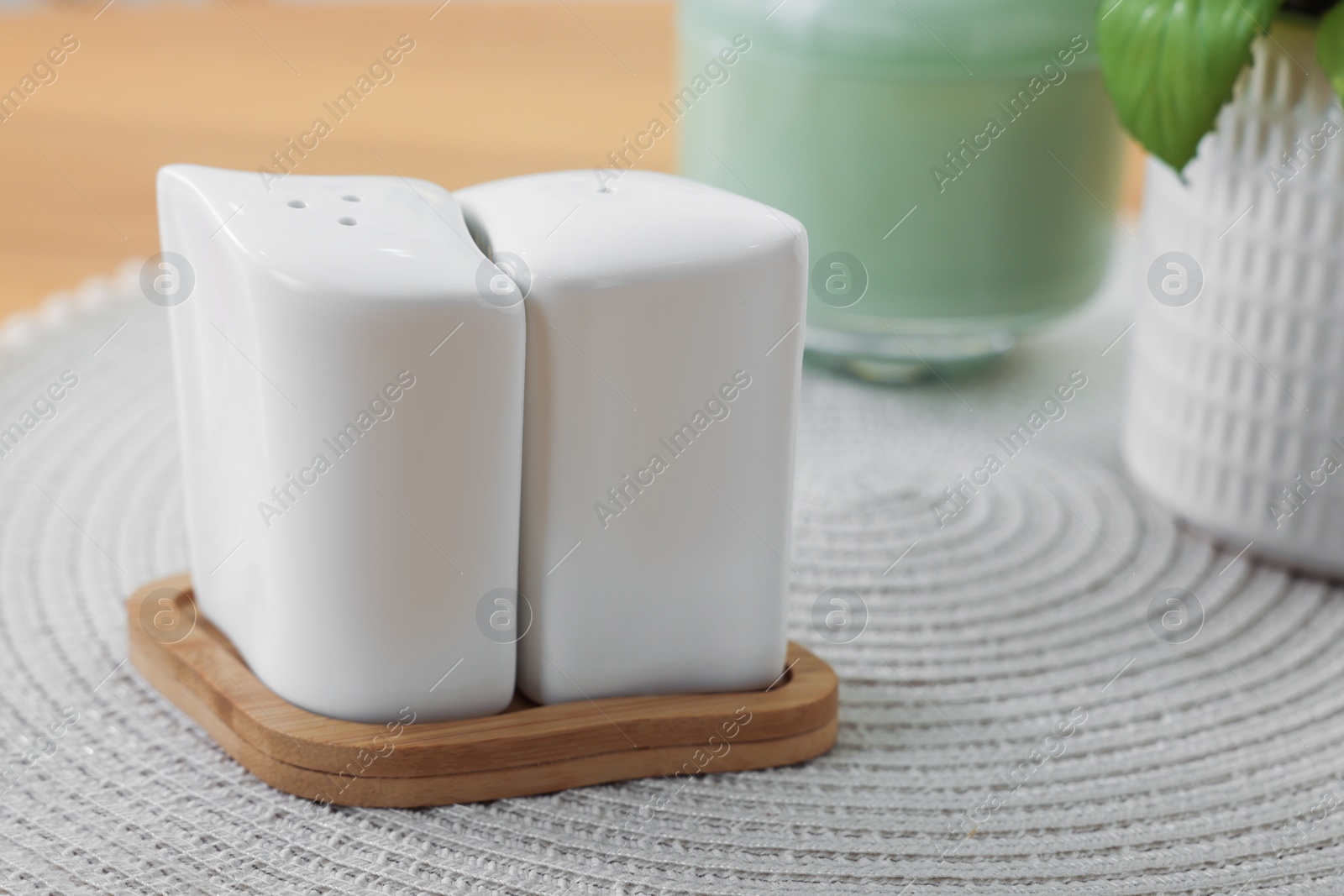 Photo of Ceramic salt and pepper shakers on table, closeup