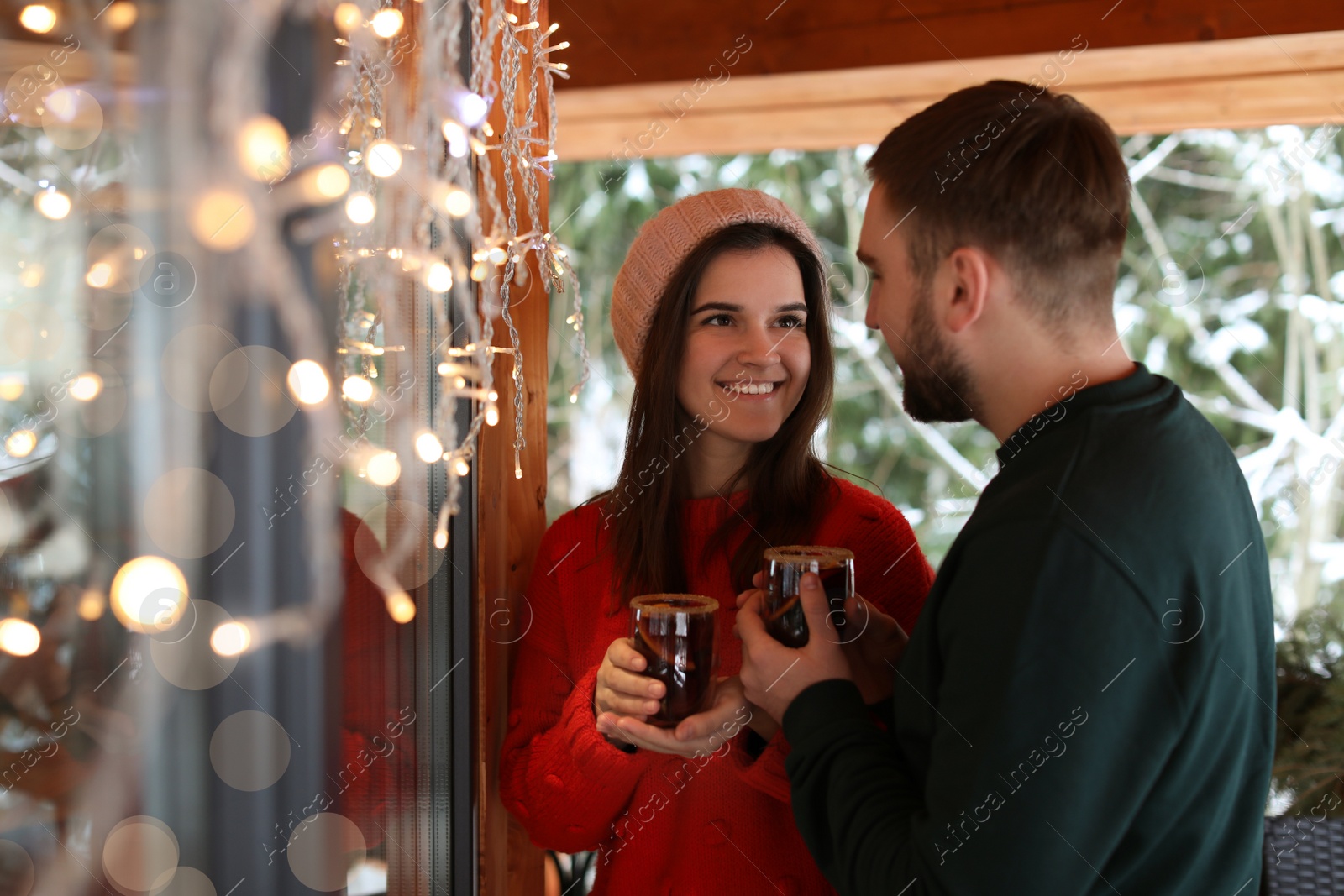 Photo of Lovely couple with tasty mulled wine in cafe. Winter vacation