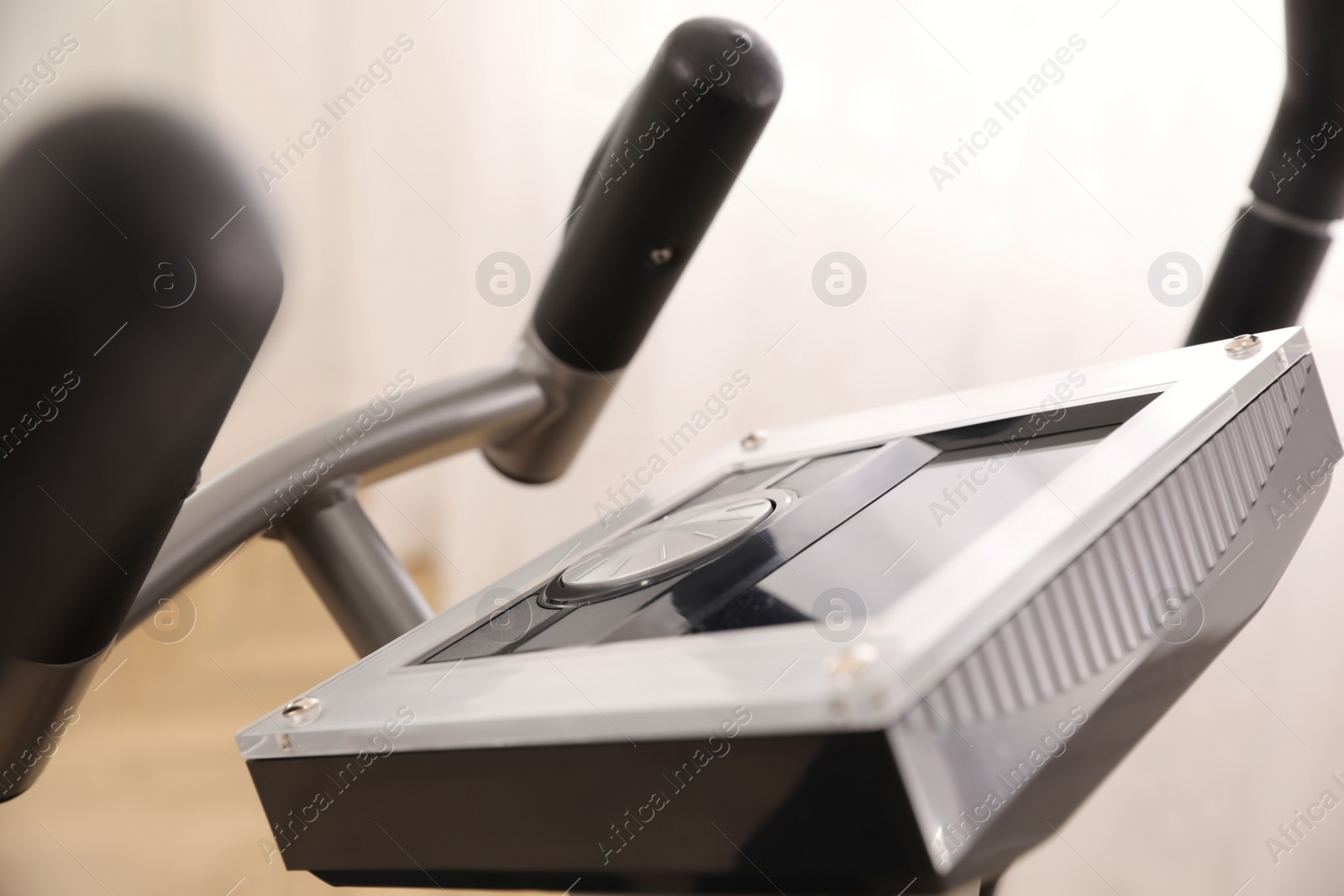 Photo of Control panel of modern elliptical machine cross trainer on blurred background, closeup