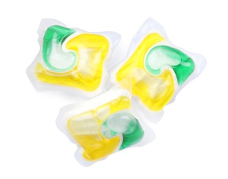 Photo of Many dishwasher detergent pods on white background, top view